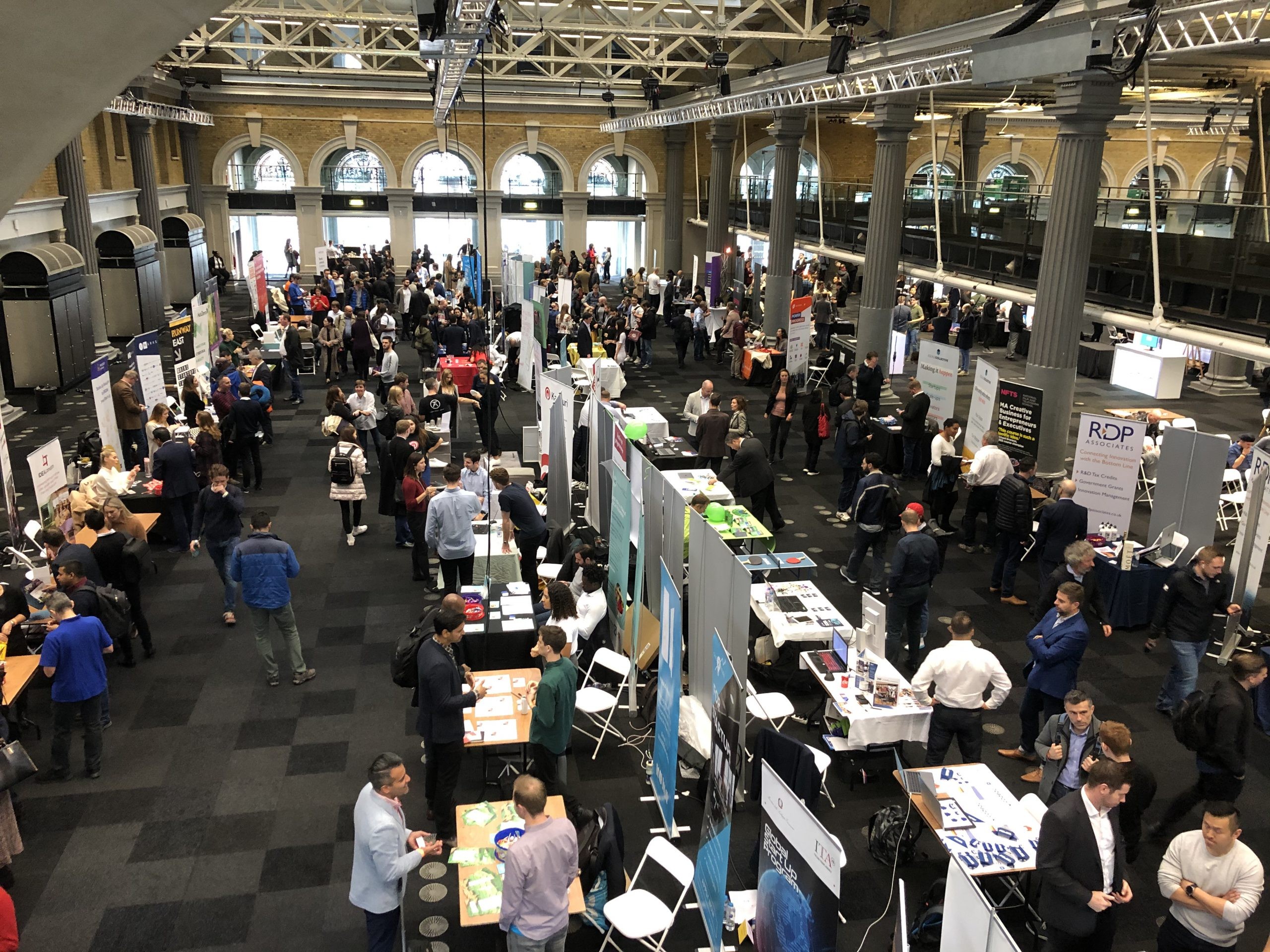 Birds eye view of 100s of stands in a conference hall at London tech day 2020