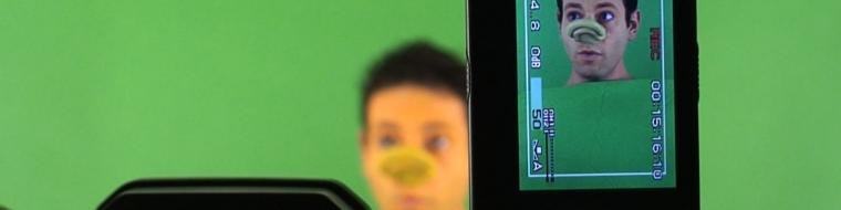 A camera films in a green screen studio